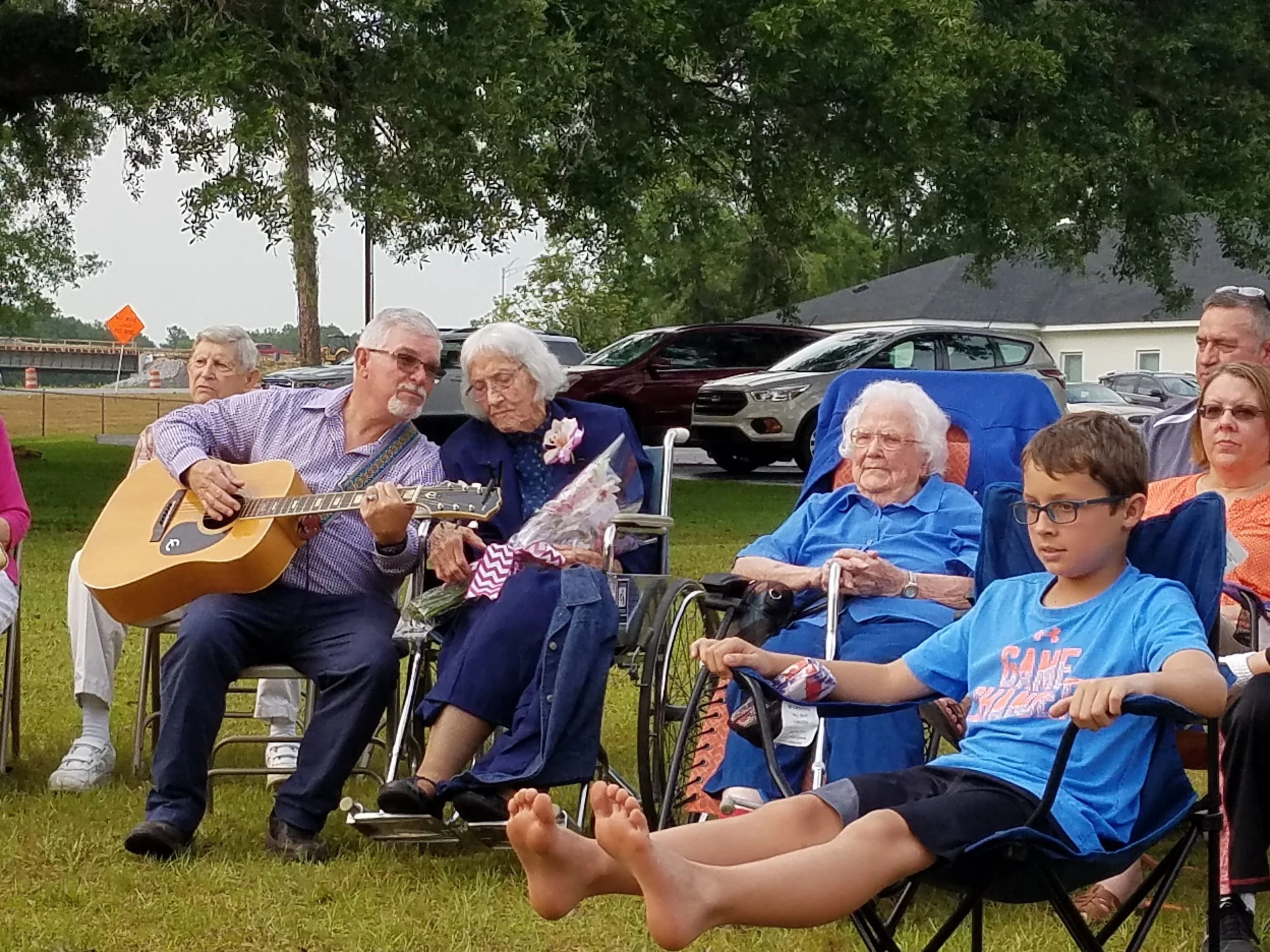 Church community gathering around a campfire